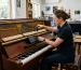 Piano technician performing Piano tuning Sunshine Coast service on upright piano in repair workshop