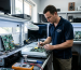 Technician fixing audio equipment motherboard