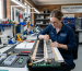 Technician fixing common digital piano problems at Brocky’s Electronics Sunshine Coast